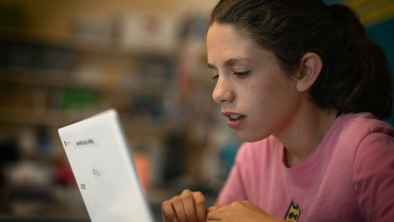 A student at Riverview School works on a laptop while in the classroom.