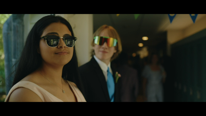 Two students from Riverview School wearing sunglasses posing for prom pictures.